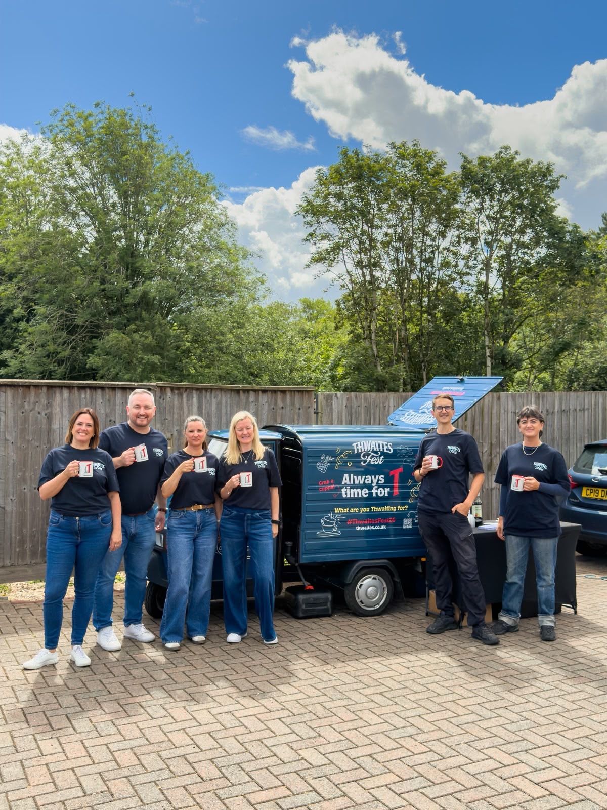Staff group photo with tea truck
